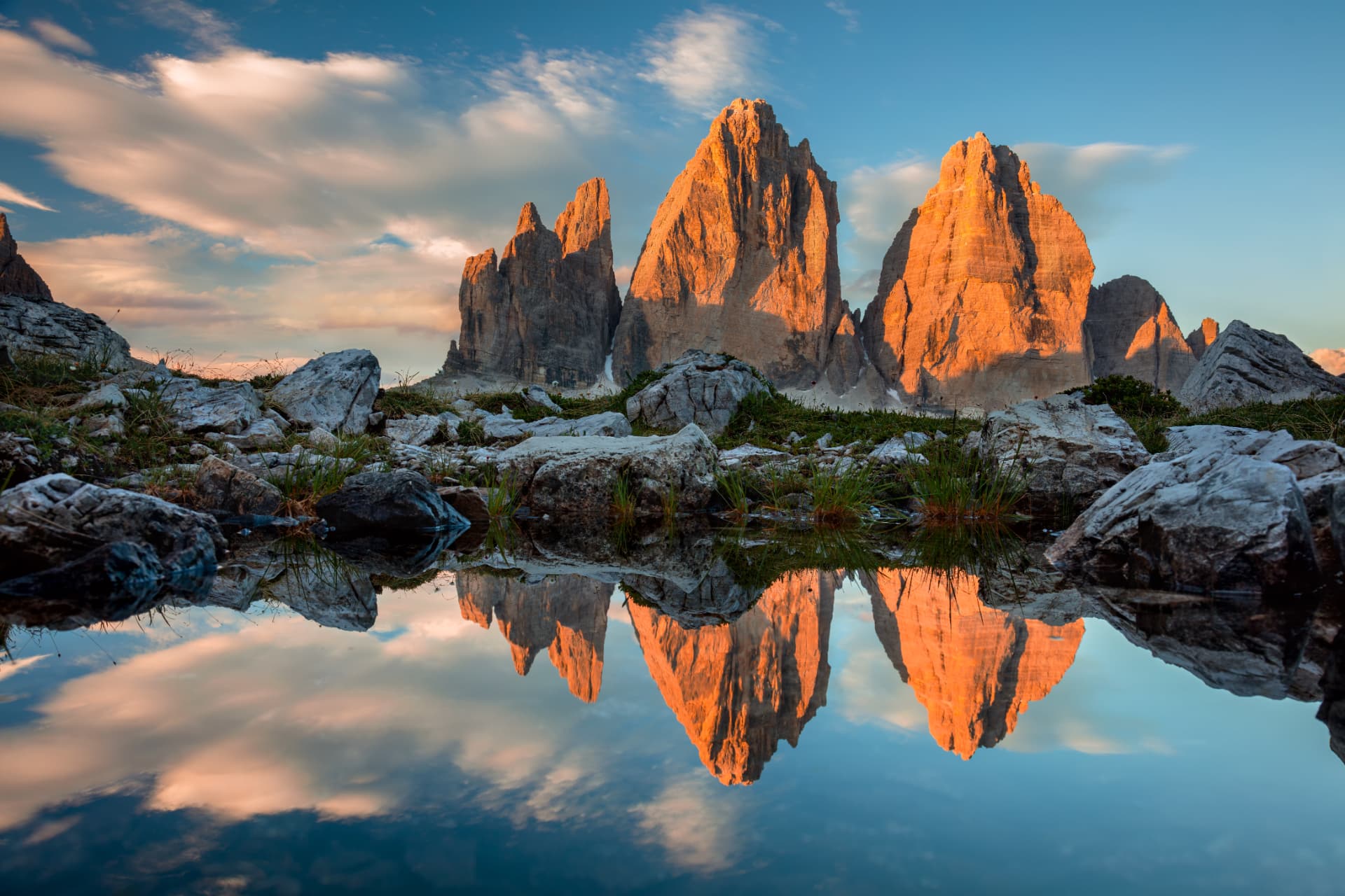 The Tre Cime di Lavaredo at sunset, reflected in still water